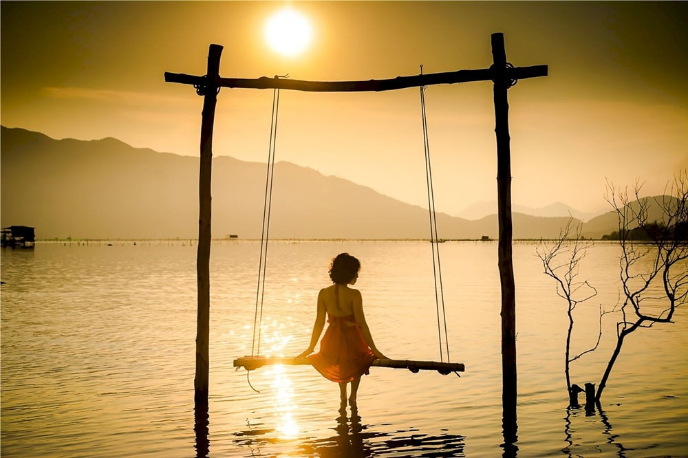 Surrounded by the majestic Bach Ma Mountains, this tranquil lagoon creates mirror-like reflections that double the beauty of dawn skies